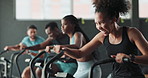 Tough, gym or woman on cycling machine for a biking workout or cardio training for endurance. Fitness class, exercise bike and healthy sports person on bicycle for hard work, challenge or wellness