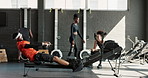 Rower, man and fitness in a gym, exercise and training with endurance and challenge with wellness. People, group or athlete with progress or rowing in a health center, active or workout with practice