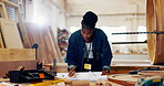 Black woman, carpenter and drawing at workshop for furniture and design. Female person, carpentry and tools for repair on startup business for training on woodwork at warehouse and factory.
