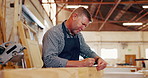 Mature man, carpenter and wood at warehouse with pencil for furniture and design. Carpentry, tools and repair on startup business as manager or supervisor in workshop or factory and manufacturing.
