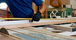 Hands, man and carpenter with measurement for wood at workshop for furniture and design. Closeup, carpentry and tape or tools on startup business for manufacturing in warehouse, factory as handyman
