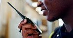 Construction site, hands and black man with radio, conversation or communication for building inspection. Architecture, zoom or mouth of male engineer with speaker speech for industrial maintenance