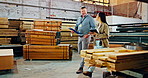 Discussion, clipboard and industry carpenters in warehouse with wood for furniture manufacturing. Tablet, checklist and professional industrial employees walking by timber material in factory.