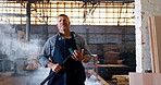 Tools, construction and face of man in warehouse for engineering, distribution and building. Dust, factory and portrait of person with sledgehammer for production, infrastructure and manufacturing