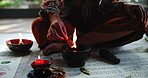 Candle, herbs and hand with natural ritual for mindfulness, healing and culture with flame. Zen, incense and person at ceremony with alternative medicine in spiritual energy for mind, body and soul