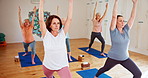 Mature woman, yoga class and mat with coach for spiritual wellness, balance or zen together. Senior people, team or yogi group in pilates or training for workout, exercise or fitness on wooden floor