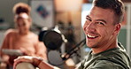 Happy man, interview and laughing with podcast in meeting for discussion, conversation or news at studio. Portrait of young man with smile or mic on air or talk show for communication or live chat