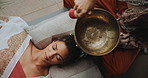 Meditation, singing bowl and woman on floor with healer for sound therapy, vibration or chakra balance from above. Healing, soul or female person with shaman for energy, cleaning or holistic care