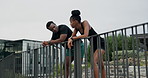 Fitness, talking or couple on break in city for workout, exercise or running for bonding or development. Relax, love or healthy black people resting together in outdoor training for teamwork or jog