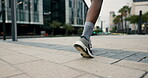 City, running and feet of athlete on floor for exercise, fitness training and performance in cardio. Black woman, ground and closeup of sports with endurance for healthy body, workout and marathon