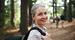 Senior, face or happy woman hiking in woods or nature for peace, trekking or outdoor adventure. Smile, relax or hiker walking in park, forest or Norway for exercise or wellness on holiday vacation
