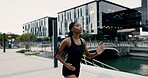 Woman, running and city promenade for exercise workout with cardio performance for health, marathon or preparation. Female person, training and urban lake for speed endurance, sprinting or fitness