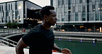 Man, running and city building for exercise workout at promenade lake for endurance, speed or cardio. Black person, physical activity and urban street for fitness training, downtown or performance