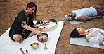 Tibetan, meditation and people outdoor with sound for indigenous spiritual healing in holistic practice. Soul, music and relax to calm vibration of singing bowl in nature with peace from instrument