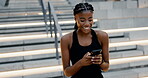Fitness, black woman and smile with smartphone by stairs for social media, exercise blog or networking. African person, happy and typing on digital technology for communication, workout app or update