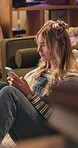 Woman, phone and sad with texting in living room for bad memory, idea and communication on floor in home. Girl, person and smartphone in lounge for thinking, contact or application for social network