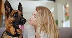 Woman, dog and kiss in home for love connection as animal owner for relax wellness, together or care. Female person, german sheperd and lounge bonding with pet for emotional support, house or happy