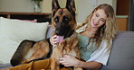 Love, relax and woman in home with dog for company, commitment and loyalty with animals on couch. Pet care, woman and German Shepard in living room for bonding, support and smile together on sofa