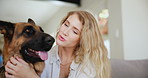 Woman, dog and kiss in home for care connection as animal owner for wellness, together or loving. Female person, german shepherd and lounge bonding with pet for trust support, embrace or happiness