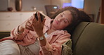 Phone, night or bored woman with depression in home with broken heart or bad news in message. Social media, couch and sad female person reading a late break up text with stress or anxiety in chat