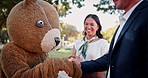 Businessman, mascot and smile with handshake in outdoor for congratulations on deal and agree for partnership and promotion. People, cartoon character and costume for entertainment with fun and happy