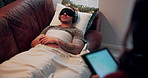 Man, patient and sleep therapy on sofa with blindfold, headphones and test for wellness on tablet. Psychology, people and digital touchscreen for report, results and exam for rest on couch at clinic