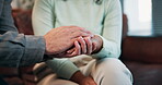 Therapy, closeup or couple holding hands for support, love or marriage commitment in counselling. Trust, kindness or calm man with wellness or woman on couch or sofa for faith, hope or care to relax