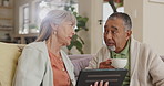 Senior, couple and relax with tablet in home for reading news with online article or blog over coffee in retirement. Elderly, people and talking about video on internet with tech on streaming website