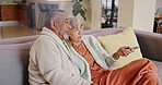 Relax, senior couple and watching tv in home living room together, conversation and interracial people bonding on couch. Television, elderly man and woman on sofa for show, news and streaming movie