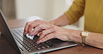 Senior woman, hands and laptop for typing in home, online search and scroll on news website. Elderly female person, writing and network for communication, closeup and internet banking in retirement