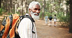 Senior, hiking or happy black man in nature walking on outdoor adventure for forest camping on holiday vacation. Survival, explore trail or African traveler in woods with backpack for trekking in USA