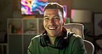 Happy man, face and gamer at night by desk, reflection and neon screen for live streaming to play. Person, excited and portrait with headphones or console and confident for online competition in home
