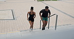 Stairs, running and black couple with exercise, city and wellness with workout and progress. Fitness, people and steps with athlete, training and runner with breathing and cardio with energy