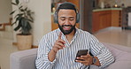 Phone, music and happy man dance with headphones on a sofa for streaming, service or sign up subscription at home. Radio, sound and male person in a living room with digital track, playlist or audio