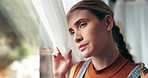 Girl, thinking and window in home with anxiety, memory or decision for studying, debt or education. Woman, person or student with vision, reflection or stress for exam results by curtains in house