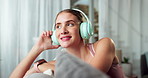 Woman, headphones and music on sofa with thinking, smile and relax with memory on holiday in living room. Girl, listening and sound with subscription on web for audio streaming on couch in apartment