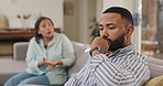 Divorce, fight and couple on a sofa with stress, anger or blame, guilt or confrontation at home. Marriage, crisis and sad man ignore shouting woman in a living room for break up, dispute or disaster