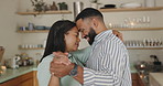Couple, dancing and smile in home kitchen with care, bonding and holding hands for connection. Man, woman and moving together with love, happy and steps with rhythm, memory and fun in apartment