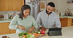 Couple, cooking and tablet in kitchen for recipe, reading and search for instructions on web in home. Man, woman and digital touchscreen for tutorial with vegetables, nutrition and meal prep for diet