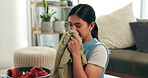 Cleaning, laundry and smelling clothing with woman in living room of home for housework or chores. Clothes, housekeeping and confident smile of happy young person in apartment for household hygiene