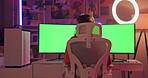 Green screen, computer and girl gamer in home with headphones, gaming system and technology for entertainment. Female person, live streaming on pc for esports or virtual competition and multiplayer.