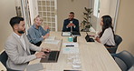 Business people, meeting and documents in boardroom for group discussion, start or review at startup. Men, women and team with leader, laptop or diversity in modern office with agenda at media agency