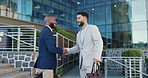 Businessman, handshake and meeting with colleague in city by steps outside building for greeting or introduction. Business people walking and shaking hands with employee for partnership or welcome