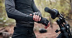 Hands, gloves and prepare with bike in nature for fitness, adventure or outdoor for travel by trees. Person, cycling and ready with safety, transport and extreme sport in competition, race or contest