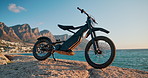 Beach, sky and off road motorcycle for travel, adventure and extreme sport in nature at summer race. Transport, dirt bike or motorbike with ocean, mountain and challenge with power, speed and machine