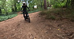 Man, forest and dirt bike on trail for extreme sport, race and fast on adventure in nature. Person, rider and motorcycle for speed by trees on outdoor path in competition, contest or journey in woods