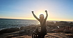 Person, motorbike and celebrate by ocean for travel, adventure and off road success or extreme sports. Back of a biker in race with freedom, yes and winning for journey and biking by a beach or sea