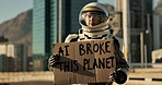 Astronaut, city and board with sign for planet, message or alert signal of news or problem on earth. Space traveler showing billboard or notification for crisis, awareness or protest in an urban town
