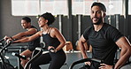 Man, face and fitness in gym, tired and stop with training or exercise to build muscle on arms or legs. People, crosstrainer or bike for cardiovascular strength and slow down for break or energy.