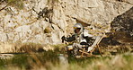 Astronaut, relax and drink for earth explore or mountain nature or planet discovery, mission or travel. Person, spacesuit and helmet on chair in wood environment with beer beverage, rest or journey